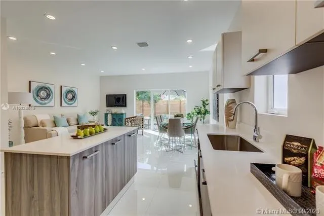 a kitchen with stainless steel appliances kitchen island granite countertop a sink and cabinets