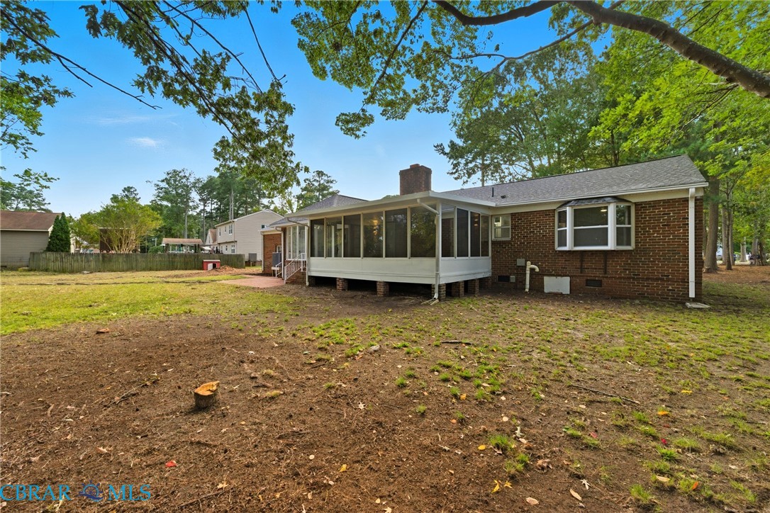 718 Dandy Loop Road Yorktown, VA 23692 - Photo 33 of 42 Back of property with a sunroom, a chimney, brick siding, and crawl space