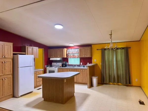 a kitchen with refrigerator and cabinets