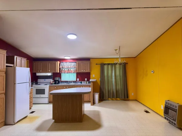 a kitchen with a refrigerator and a stove