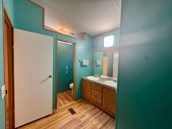 a room with a mirror and a wooden floor