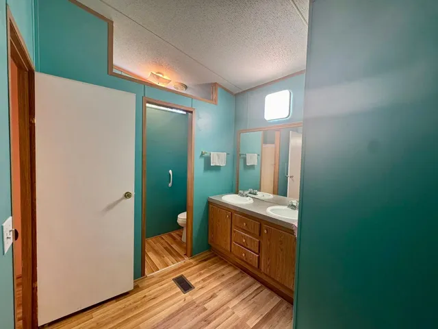 a room with a mirror and a wooden floor