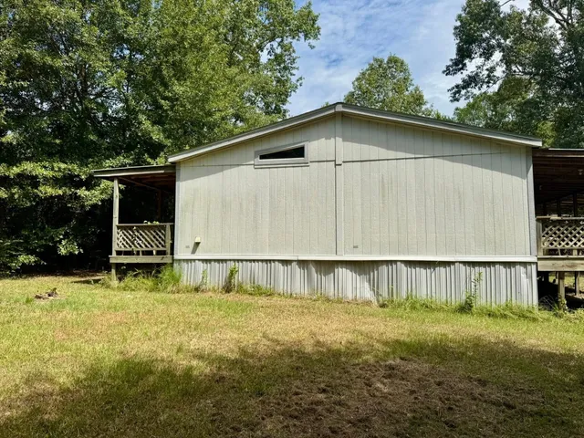 a backyard of a house with barbeque oven