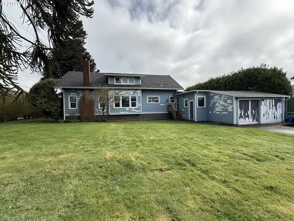 a view of a house with a garden and deck