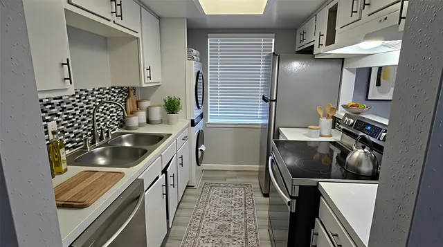 a kitchen with granite countertop a sink and a stove top oven