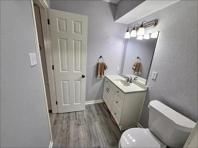 a bathroom with a sink and mirror with toilet