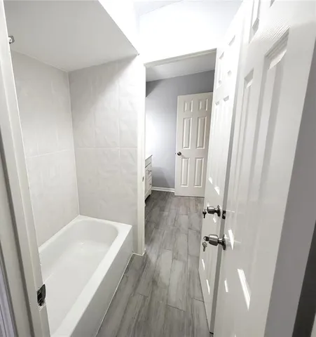 a bathroom with a bathtub and a shower