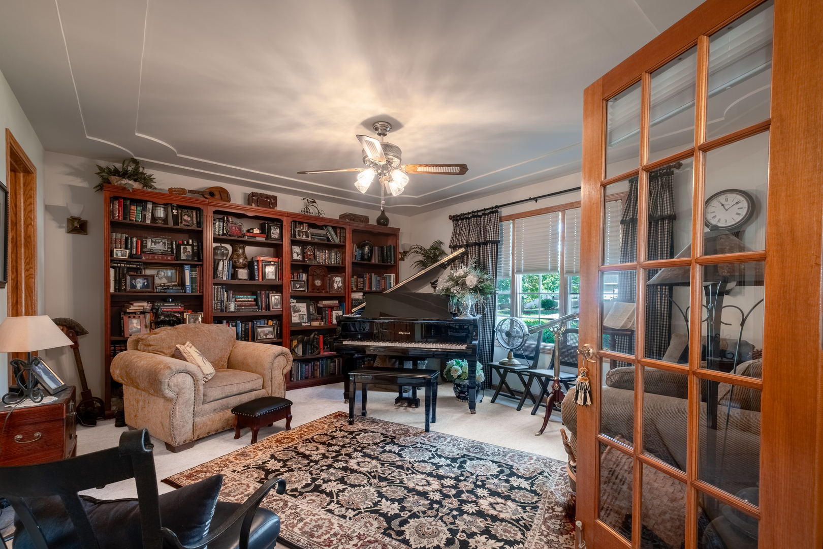 308 Calla Drive Manhattan, IL 60442 - Photo 3 of 30 a living room with furniture a piano and a bookshelf