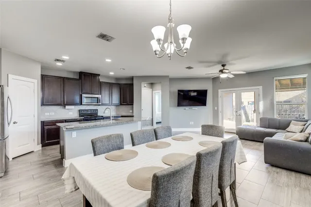 a large kitchen with a table and chairs