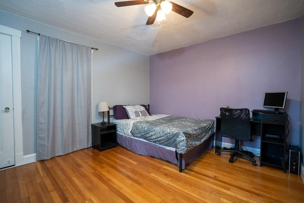 19 Perkins Street Springfield, MA 01118 - Photo 15 of 29 a bedroom with a bed and a chandelier
