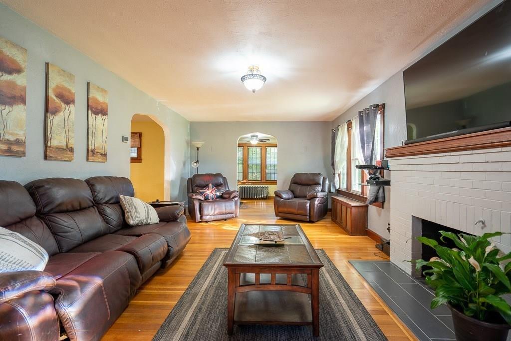 19 Perkins Street Springfield, MA 01118 - Photo 2 of 29 a living room with furniture a fireplace and a flat screen tv