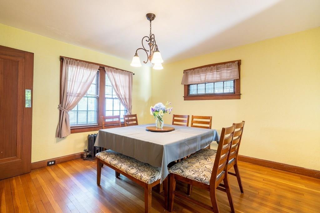19 Perkins Street Springfield, MA 01118 - Photo 6 of 29 a dining room with furniture a chandelier and wooden floor