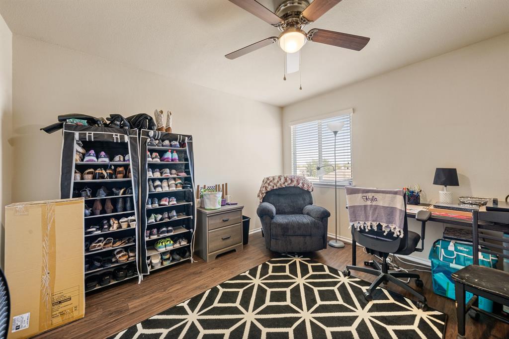 6544 Mundo Drive Waco, TX 76712 - Photo 12 of 21 a living room with furniture a rug and a book shelf