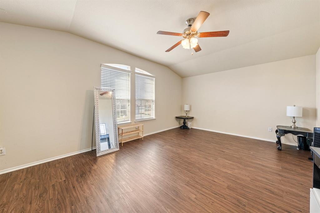 6544 Mundo Drive Waco, TX 76712 - Photo 15 of 21 an empty room with wooden floor fan and windows
