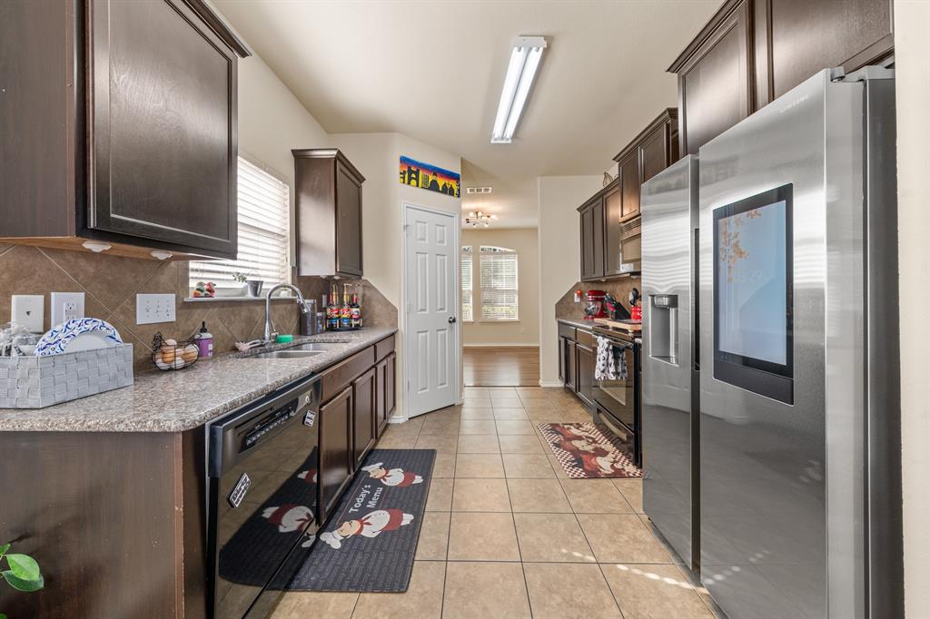 6544 Mundo Drive Waco, TX 76712 - Photo 3 of 21 a kitchen with granite countertop a sink and cabinets
