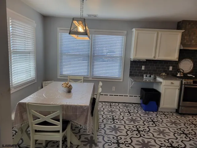 a bathroom with a granite countertop sink and a toilet