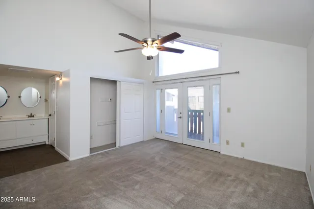 a view of a chandelier and a ceiling fan in a room