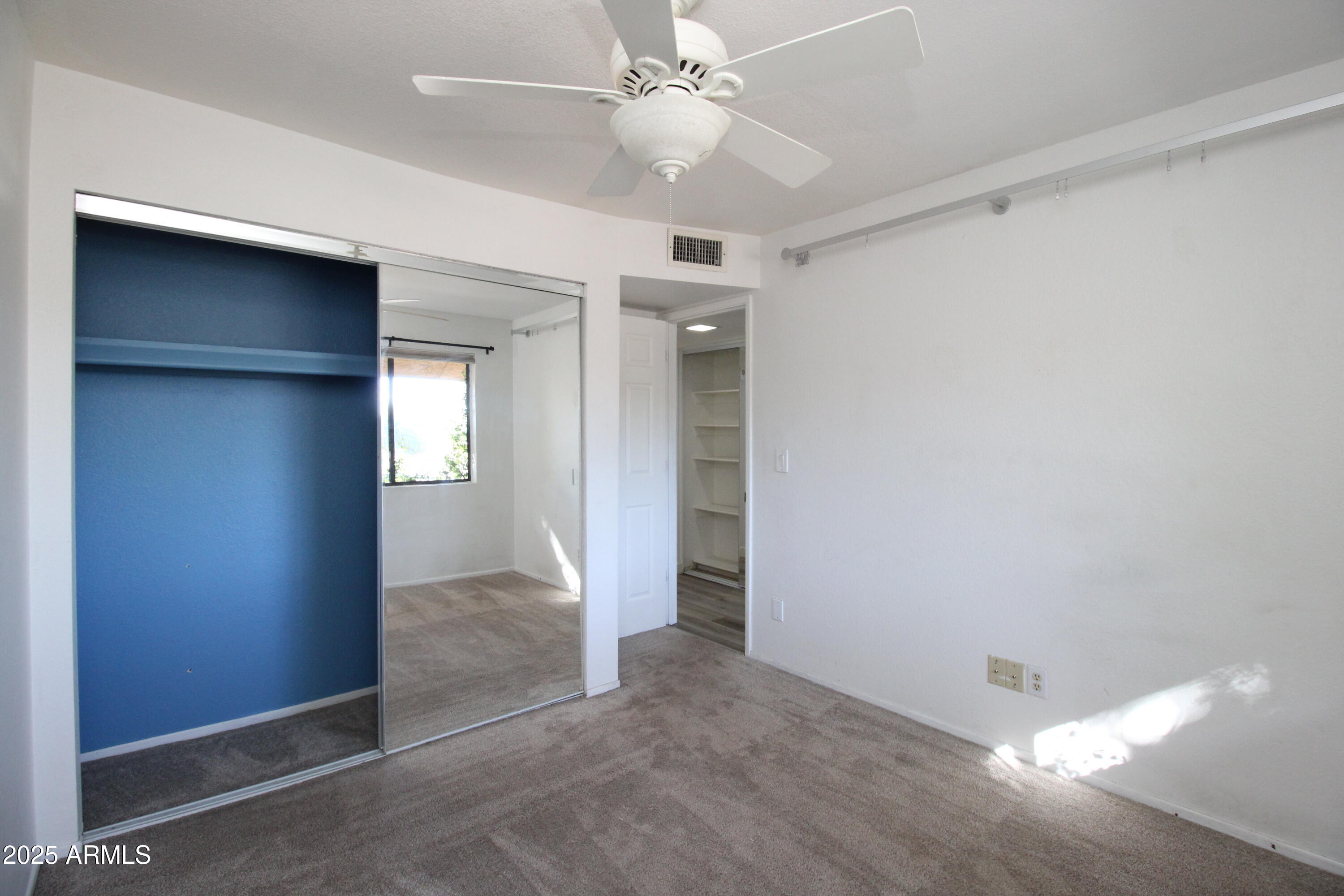 5330 North Central Avenue, Unit 19 Phoenix, AZ 85012 - Photo 18 of 33 an empty room with closet and a ceiling fan
