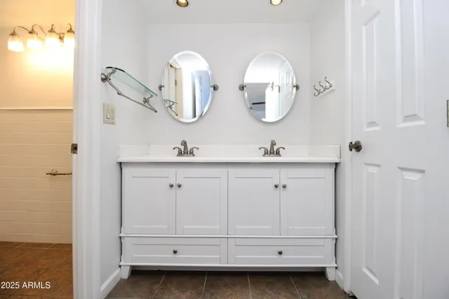 a bathroom with a double vanity sink and mirror