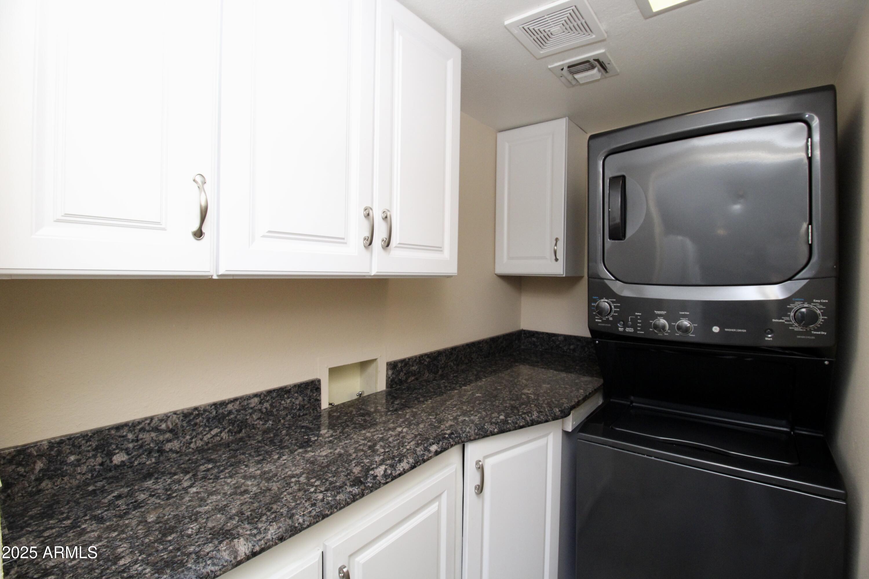 5330 North Central Avenue, Unit 19 Phoenix, AZ 85012 - Photo 24 of 33 a kitchen with granite countertop white cabinets and a stove