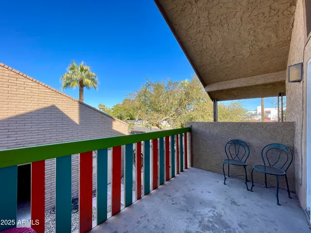 a view of a porch with furniture and floor to ceiling window