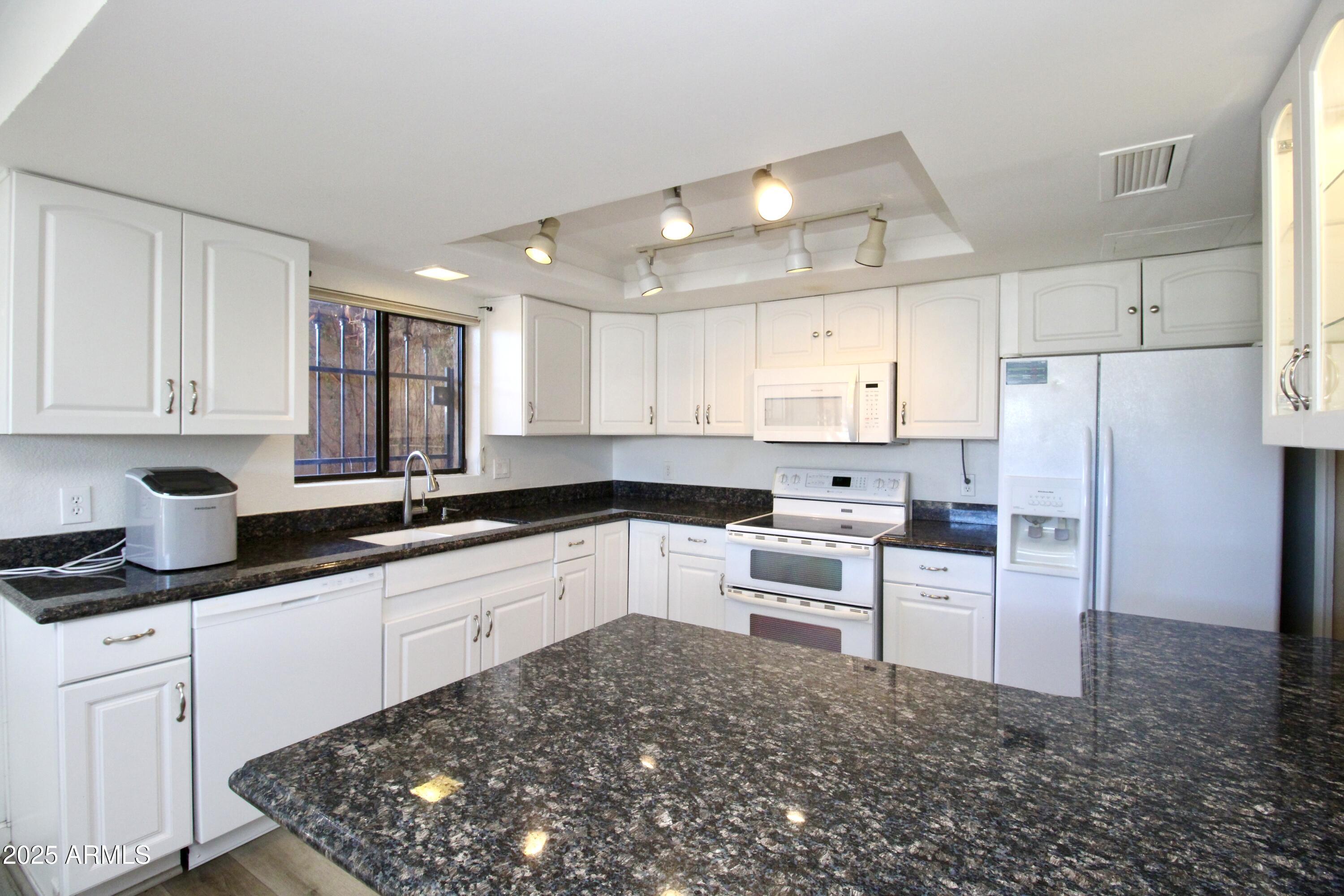 5330 North Central Avenue, Unit 19 Phoenix, AZ 85012 - Photo 3 of 33 a kitchen with refrigerator and cabinets