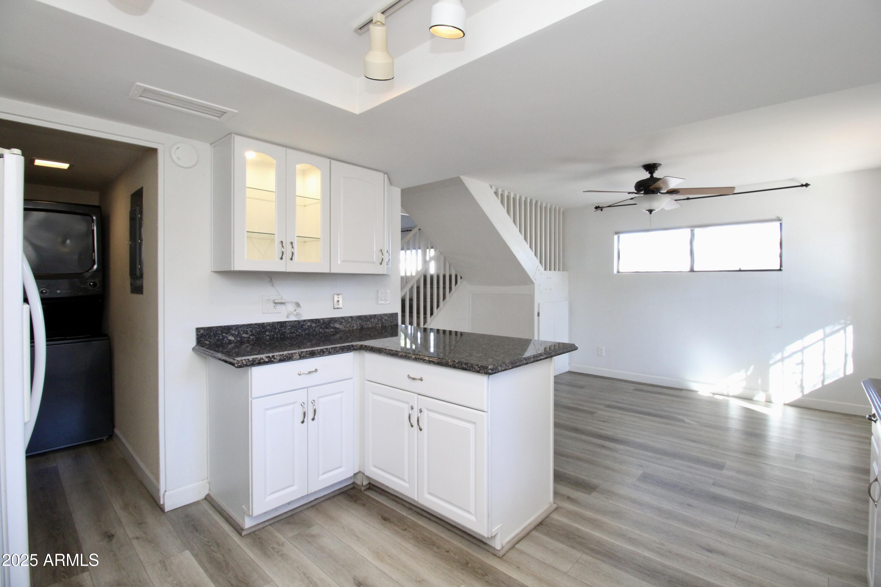 5330 North Central Avenue, Unit 19 Phoenix, AZ 85012 - Photo 5 of 33 a kitchen with granite countertop a sink cabinets and wooden floor