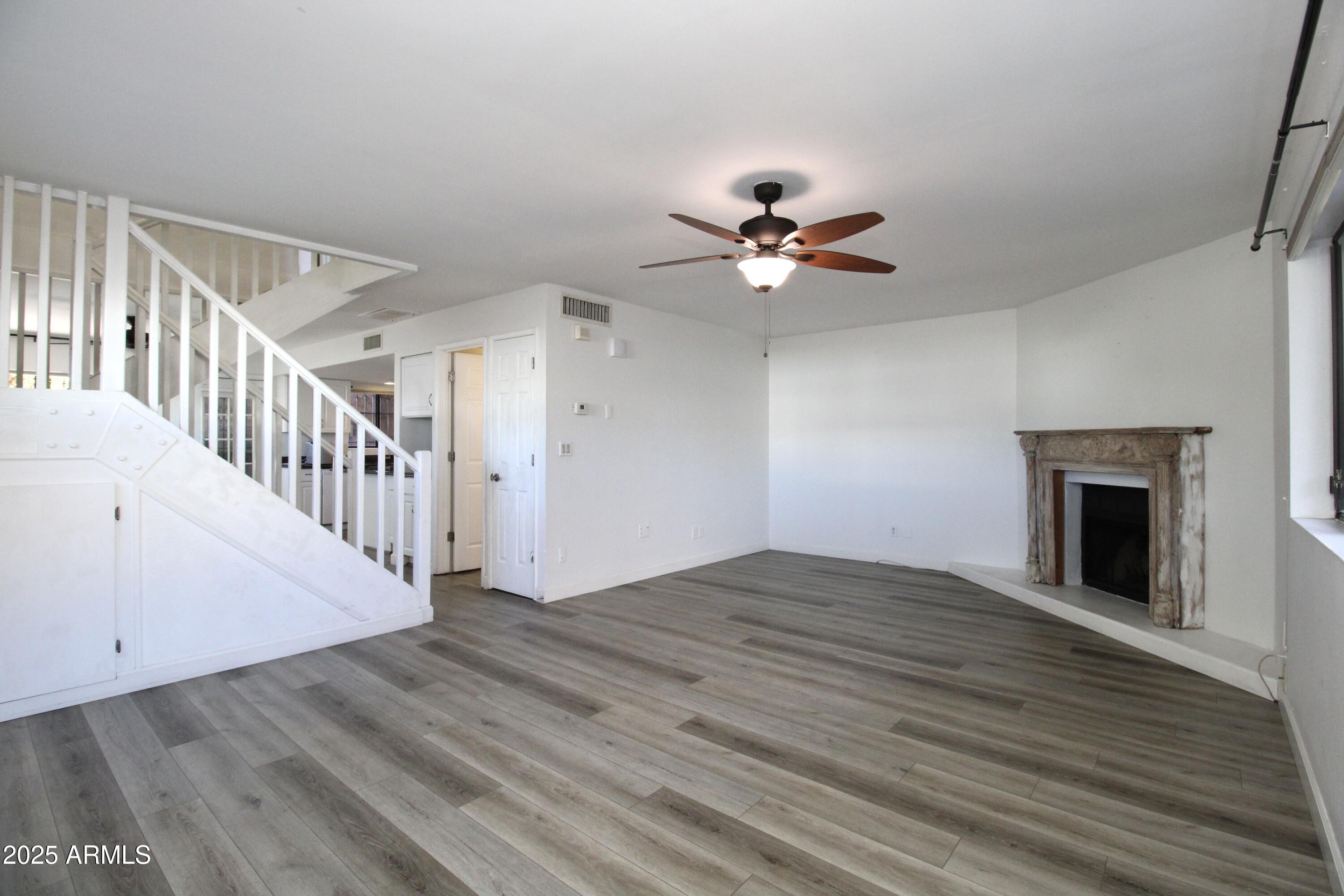 5330 North Central Avenue, Unit 19 Phoenix, AZ 85012 - Photo 7 of 33 a view of an empty room with window and wooden floor