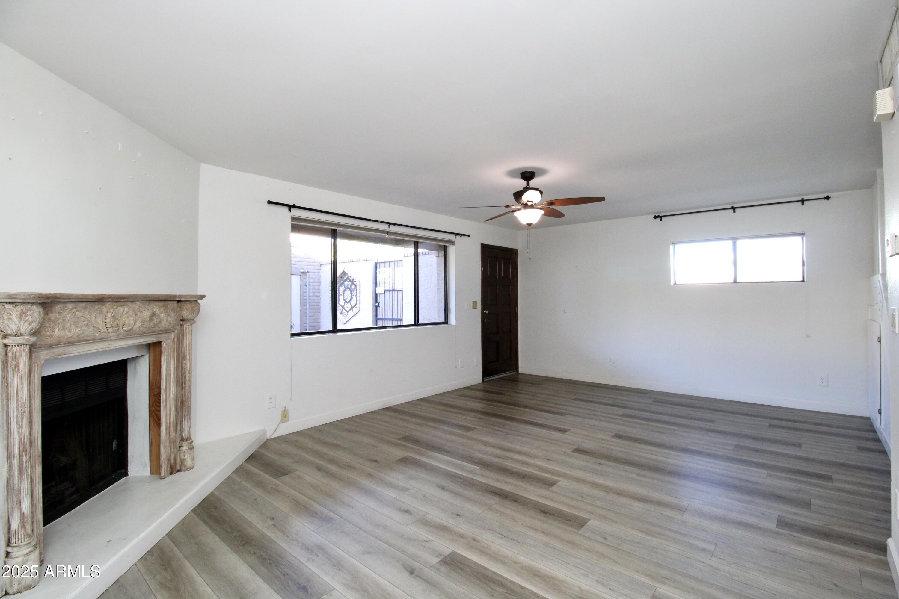 5330 North Central Avenue, Unit 19 Phoenix, AZ 85012 - Photo 8 of 33 a view of an empty room with window and wooden floor