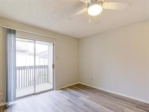 1900 Bay Area Boulevard, Unit T194 Houston, TX 77058 - Photo 13 of 21 a view of an empty room with wooden floor and a window