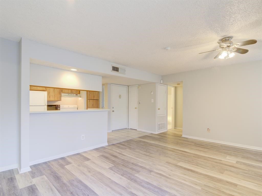 1900 Bay Area Boulevard, Unit T194 Houston, TX 77058 - Photo 15 of 21 a view of empty room with wooden floor and fan