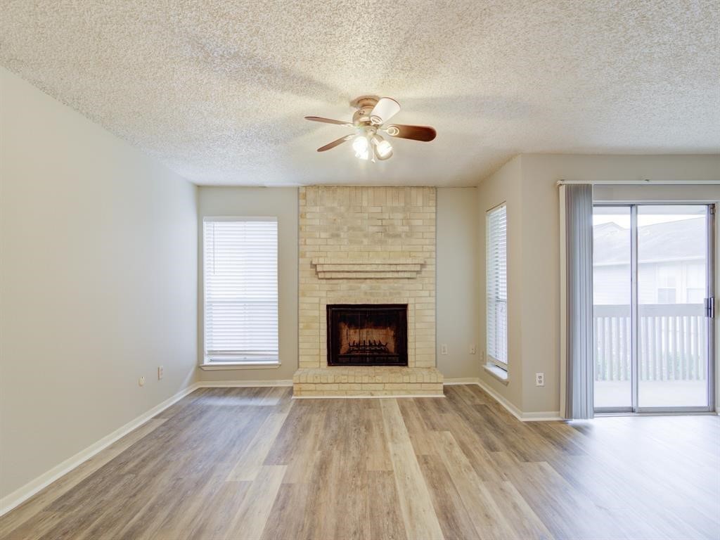 1900 Bay Area Boulevard, Unit T194 Houston, TX 77058 - Photo 2 of 21 wooden floor fireplace and windows in an empty room