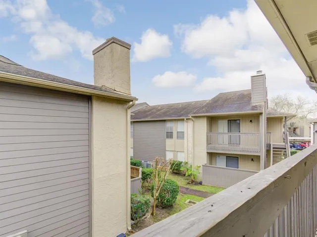 a front view of a house with plants