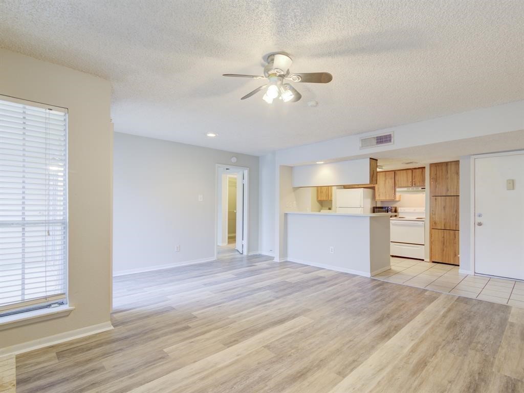 1900 Bay Area Boulevard, Unit T194 Houston, TX 77058 - Photo 4 of 21 a view of empty room with wooden floor and fan