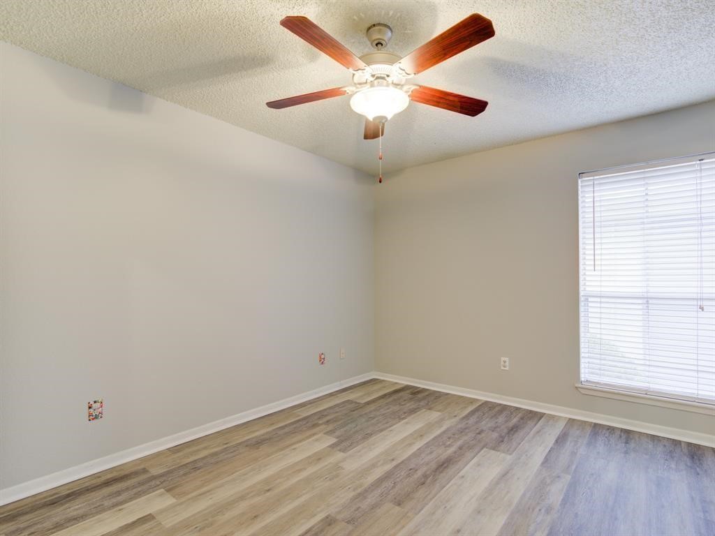 1900 Bay Area Boulevard, Unit T194 Houston, TX 77058 - Photo 5 of 21 an empty room with wooden floor and windows