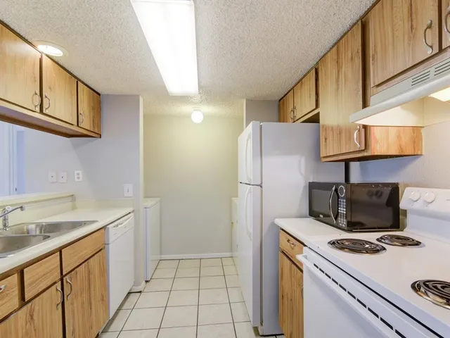 a kitchen with a refrigerator and a sink