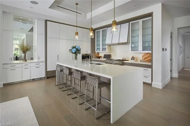 a kitchen with stainless steel appliances granite countertop a sink a stove and a refrigerator