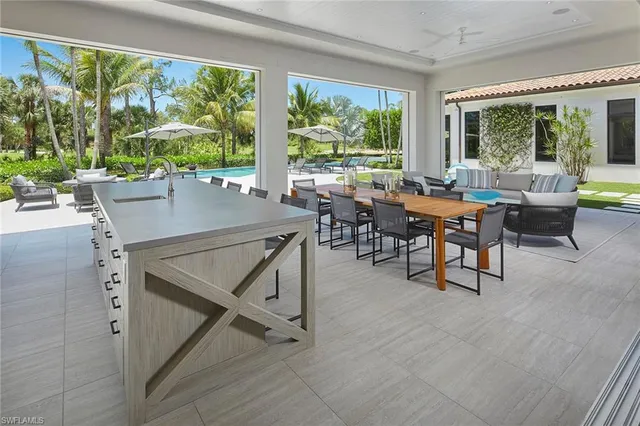 a view of a dining room with furniture large windows and wooden floor
