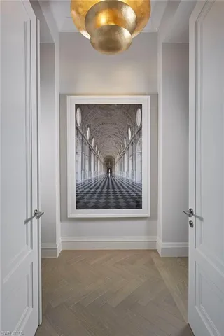 a view of a hallway with wooden shelves