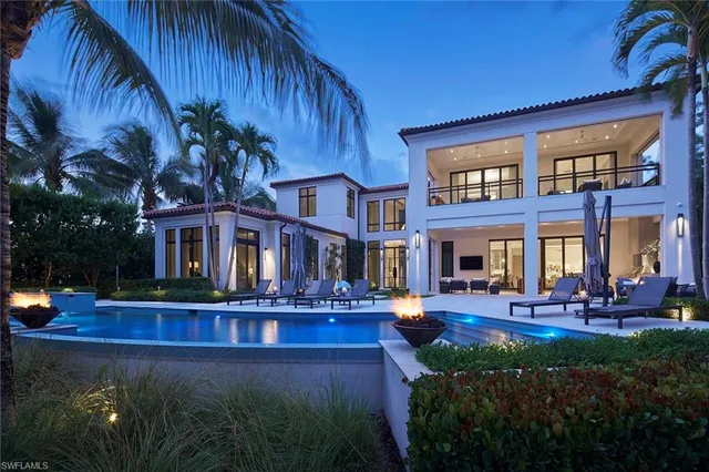 a view of a house with potted plants