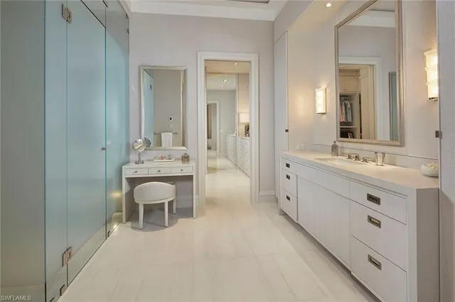 a spacious bathroom with a double vanity sink a mirror and a bathtub