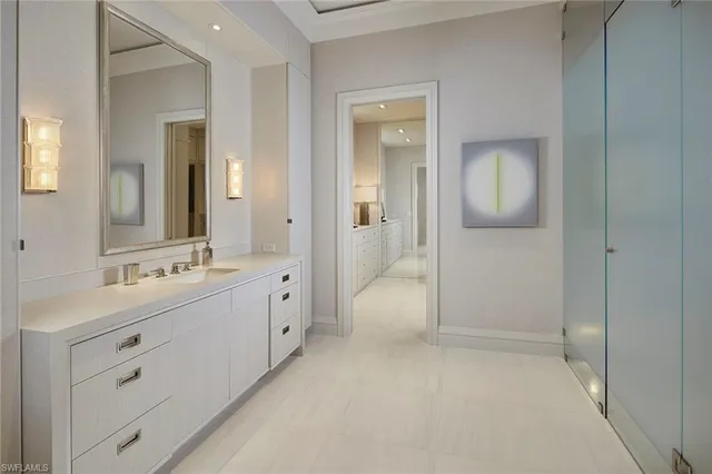 a bathroom with a shower a sink and a mirror