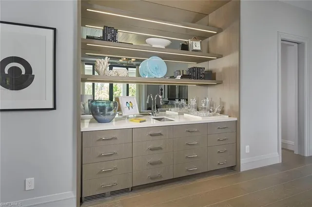 a dining room with furniture a large window and a chandelier