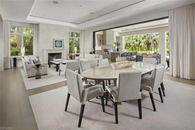 a living room with fireplace furniture and a large window