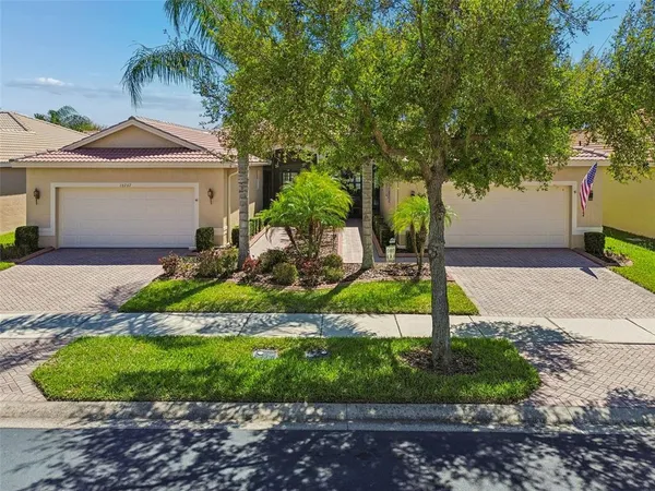 a front view of a house with a yard and garage