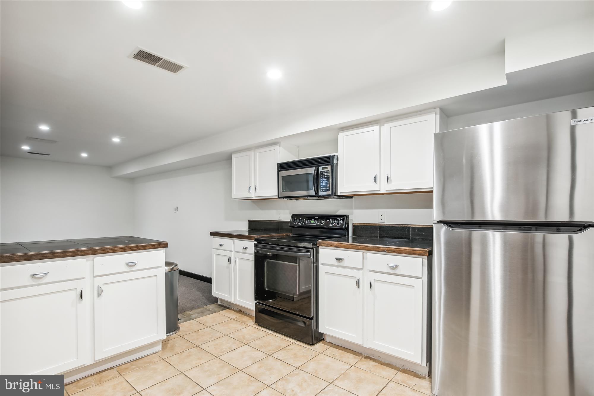 1814 19th Street Northwest, Unit A Washington, DC 20009 - Photo 50 of 58 a kitchen with white cabinets and white appliances