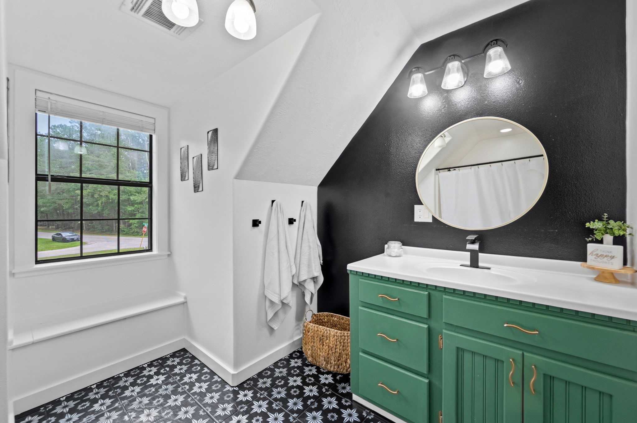 18 East Old Field Road Huffman, TX 77336 - Photo 23 of 35 Beautifully appointed secondary bath featuring stylish patterned tile flooring, a custom vanity finished in a bold designer hue, elegant lighting, & charming architectural accents that elevate the space with character & sophistication. A spacious walk-in shower adds comfort & functionality to this thoughtfully designed bathroom.