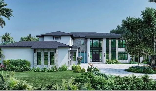 a view of a house with brick walls and a yard with plants
