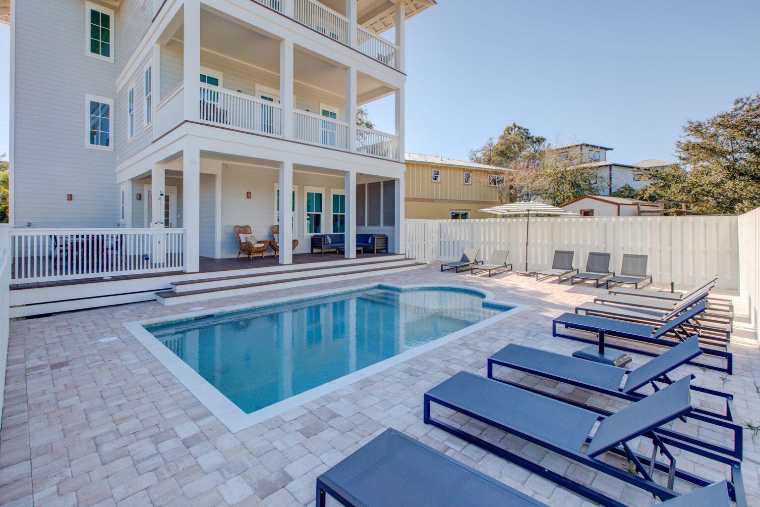70 West Seahorse Circle Santa Rosa Beach, FL 32459 - Photo 18 of 25 a view of a patio with couches table and chairs and wooden floor