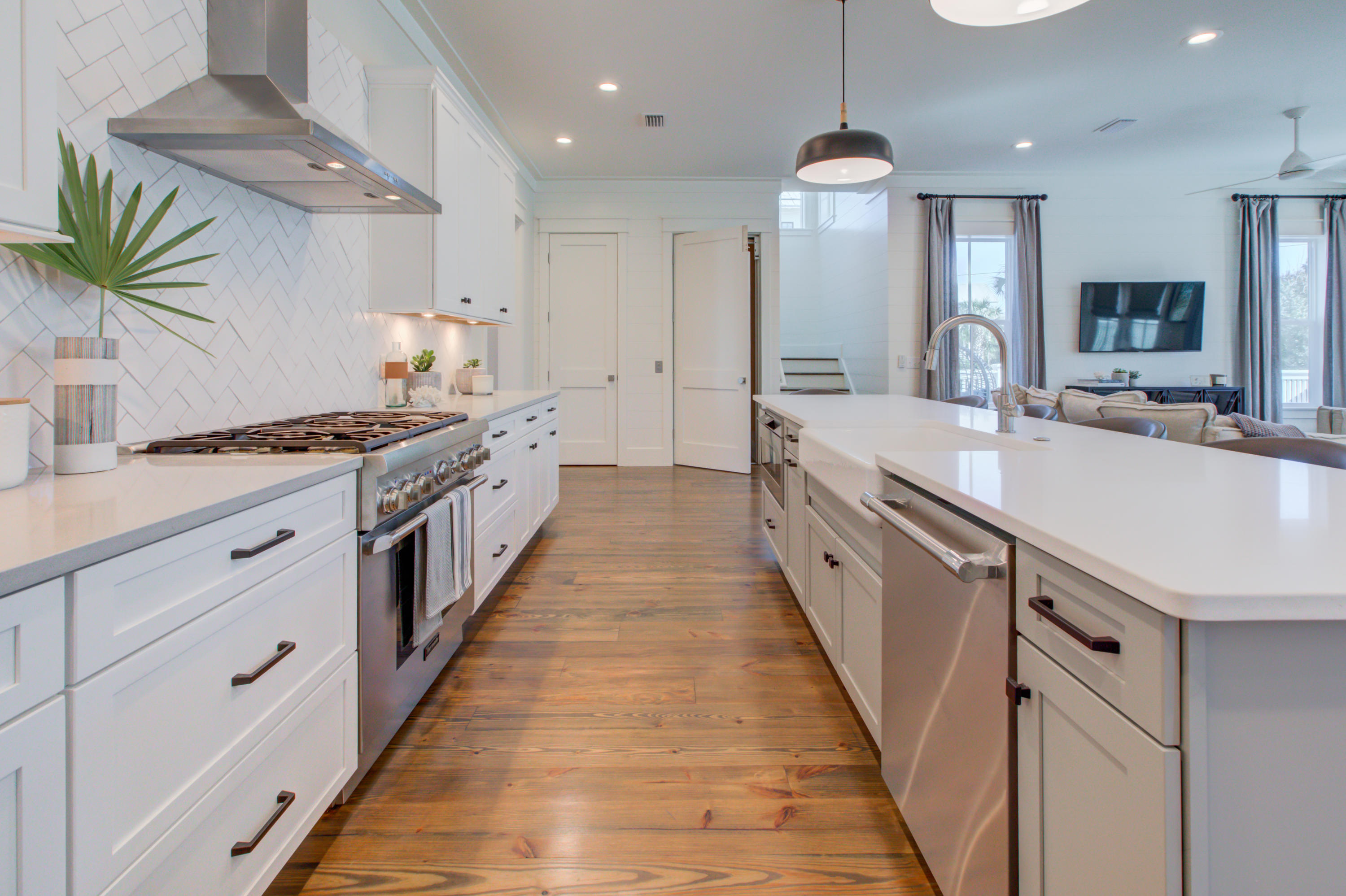 70 West Seahorse Circle Santa Rosa Beach, FL 32459 - Photo 10 of 25 a large kitchen with stainless steel appliances a sink dishwasher a stove and a kitchen island with wooden floor